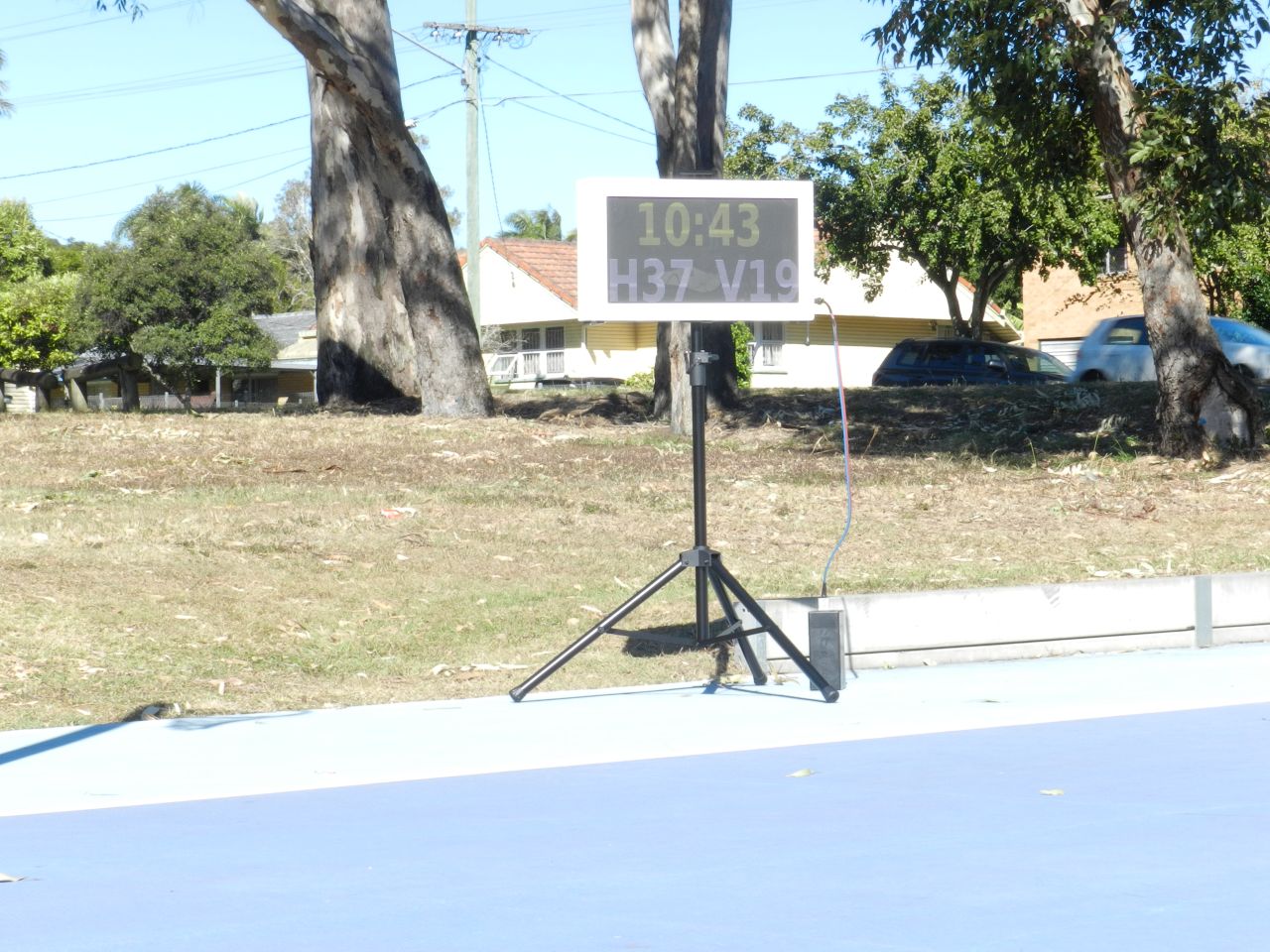 Portable LED scoreboard in use at an outdoor sports ground